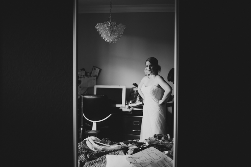 Bride looking in the mirror by Love oh love photography