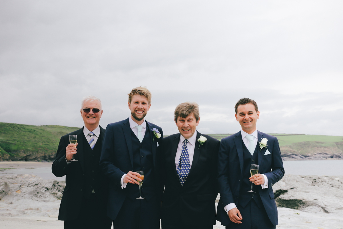 Group shot at Prussia Cove, Cornwall wedding by Love Oh Love Photography