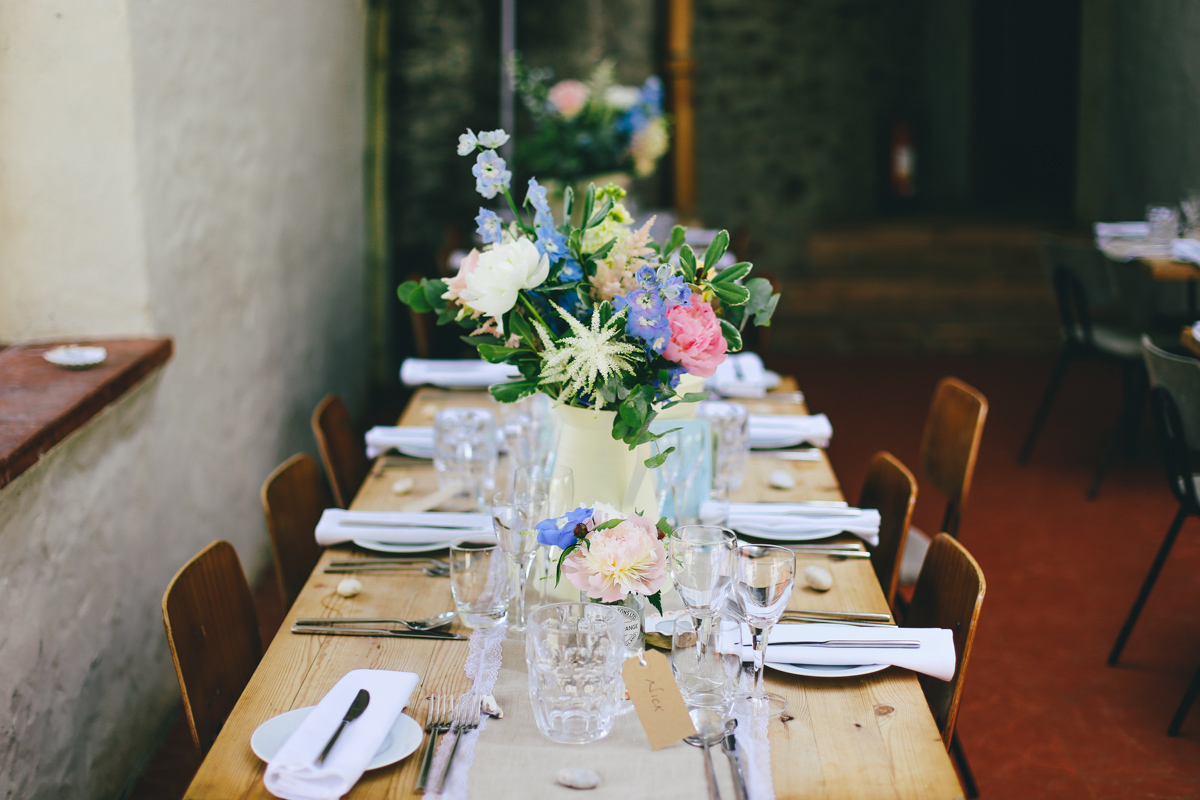 Table decorations and flowers at Prussia Cove, Cornwall wedding by Love Oh Love Photography